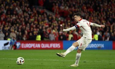 Robert Lewandowski of Poland scores in the penalty shootout during the Euro 2024 playoffs semifinal match against Wales at Cardiff City Stadium on March 26 in Cardiff