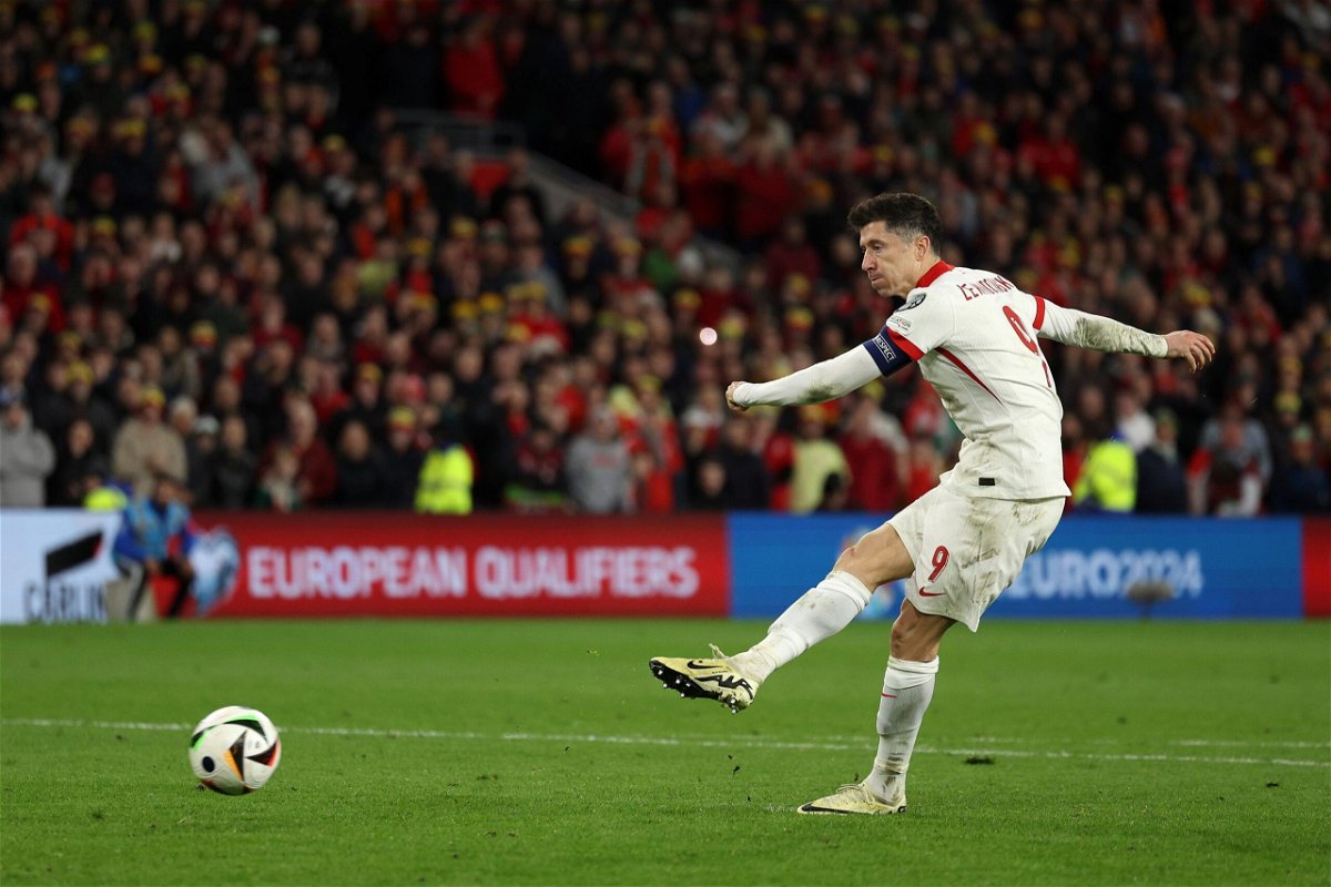 <i>Richard Heathcote/Getty Images via CNN Newsource</i><br/>Robert Lewandowski of Poland scores in the penalty shootout during the Euro 2024 playoffs semifinal match against Wales at Cardiff City Stadium on March 26 in Cardiff