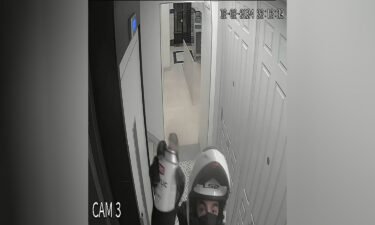 Security camera footage shows a man in a motorcycle helmet