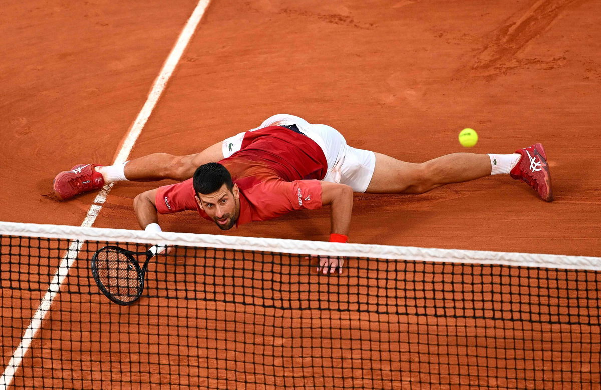 <i>Clive Mason/Getty Images via CNN Newsource</i><br/>Djokovic slides for a forehand against Francisco Cerúndolo.