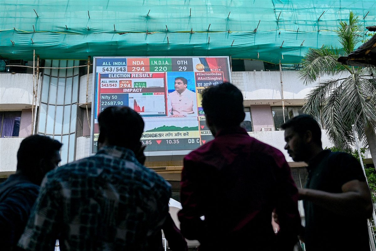 <i>Punit Paranjpe/AFP/Getty Images via CNN Newsource</i><br/>Pedestrians watch share prices on a digital broadcast outside the Bombay Stock Exchange (BSE) on the day of India's general election result in Mumbai on June 4.