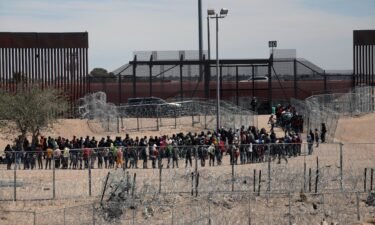 Migrants line up to be transferred by US Border Patrol in El Paso