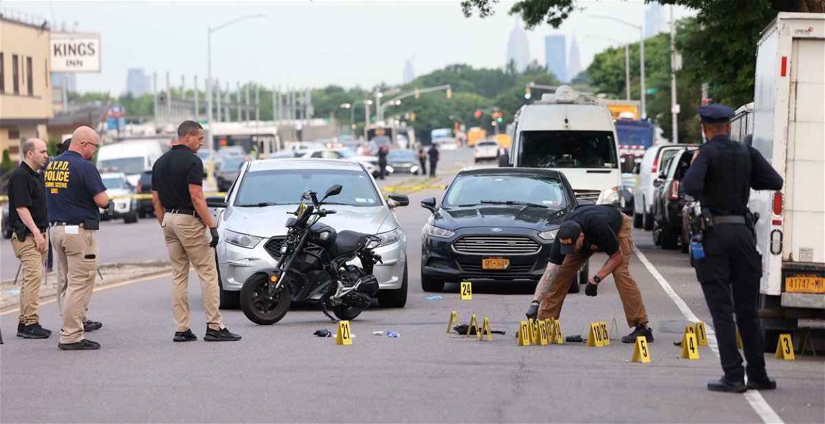 <i>James Carbone/Newsday RM/Getty Images via CNN Newsource</i><br/>Investigators are seen here at the scene where NYPD officers exchanged gunfire with a 19-year-old assailant in Queens on June 3.