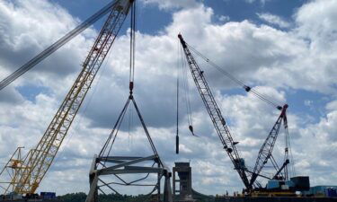 Cranes help remove a piece of the collapsed Francis Scott Key Bridge from the Patapsco River.