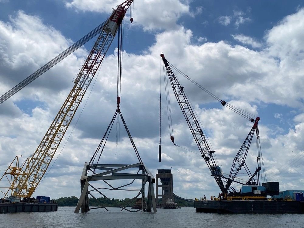 <i>Bobby Petty/DVIDS via CNN Newsource</i><br/>Cranes help remove a piece of the collapsed Francis Scott Key Bridge from the Patapsco River.