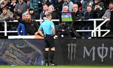 Referee Samuel Barrott checks the pitch-side video assistant referee screen to review a yellow card given to Raúl Jiménez of Fulham during the Premier League match against Newcastle United in December 2023.