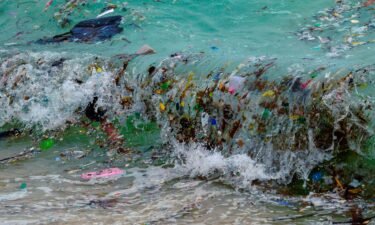 A wave carrying plastic waste and other rubbish washes up on a beach in Koh Samui in the Gulf of Thailand in January 2021.