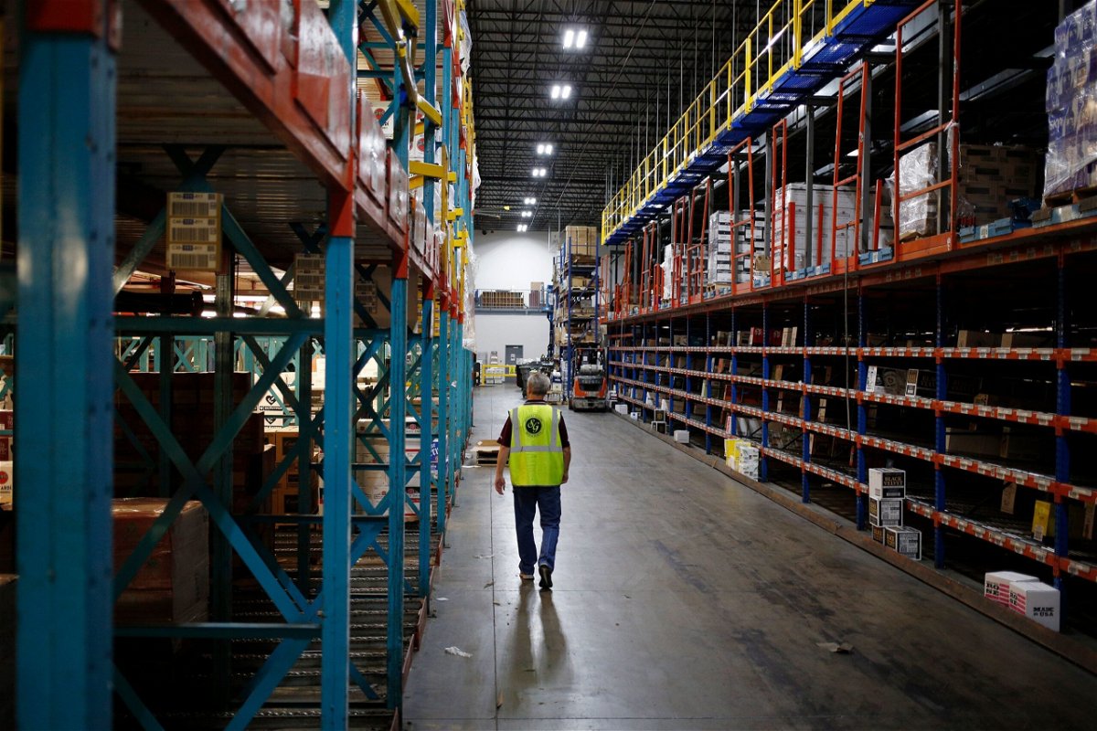 <i>Luke Sharrett/Bloomberg/Getty Images via CNN Newsource</i><br/>A worker walks down an aisle at Southern Glazer's Wine and Spirits LLC distribution center in Louisville