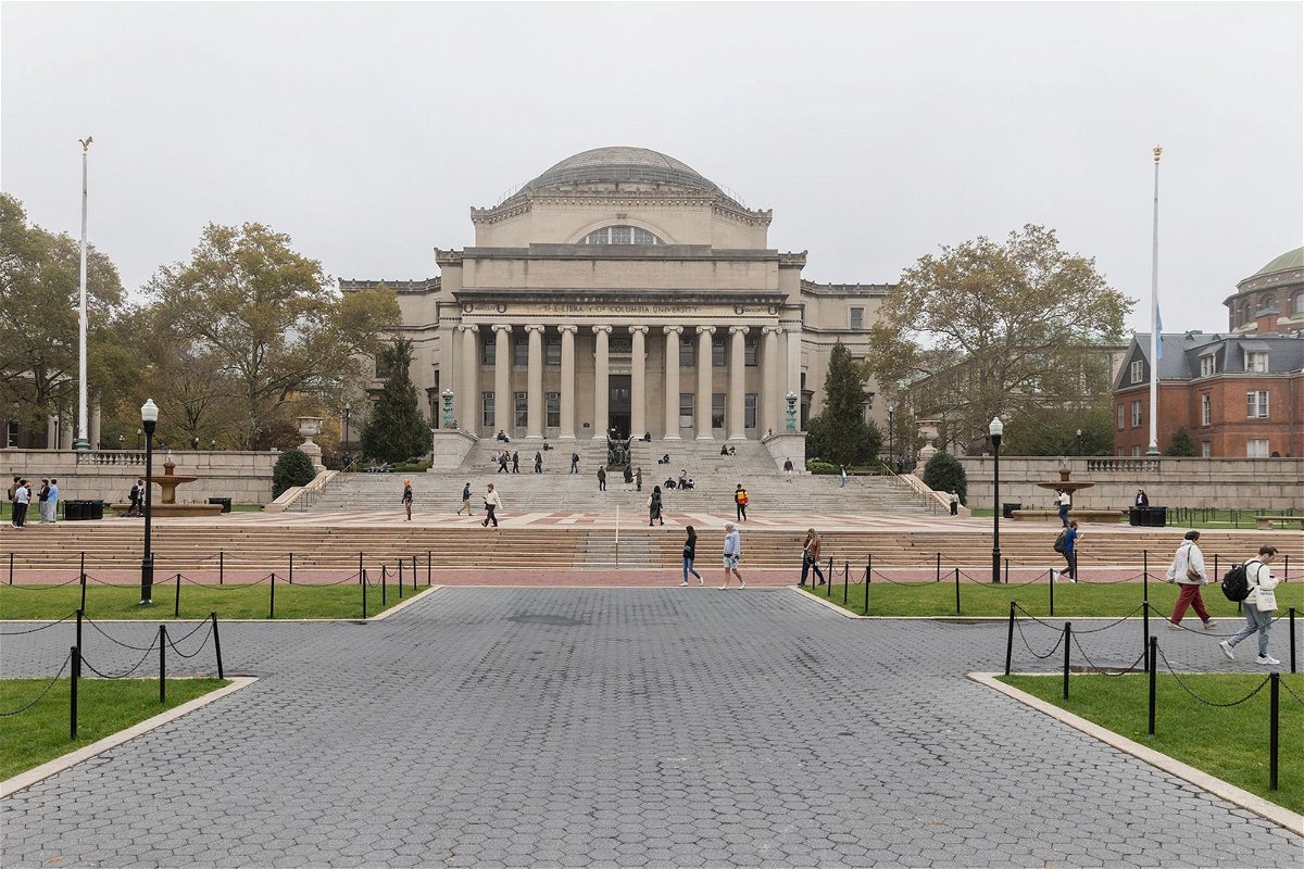 <i>Jeenah Moon/Reuters via CNN Newsource</i><br/>People walk past Columbia University in New York in October 2023. Columbia University says it’s placed three administrators on leave pending a university investigation.