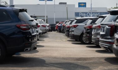 Cars sit on a Chevrolet dealership's lot on June 20 in Chicago