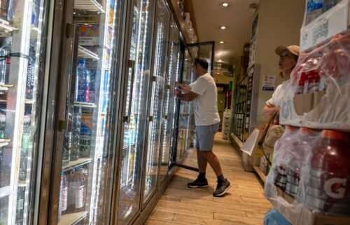 People purchase drinks in a store on a sweltering afternoon in Brooklyn on the first day of summer on June 21 in New York City. US consumer confidence teetered slightly in June.