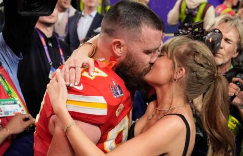 Travis Kelce kisses Taylor Swift on the field at Arrowhead Stadium after the Kansas City Chiefs beat the San Fransisco 49ers in the 2024 Super Bowl.