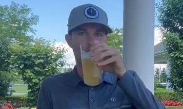 Nick Bienz sips a beer before heading into a playoff to qualify for the PGA Tour's Rocket Mortgage Classic