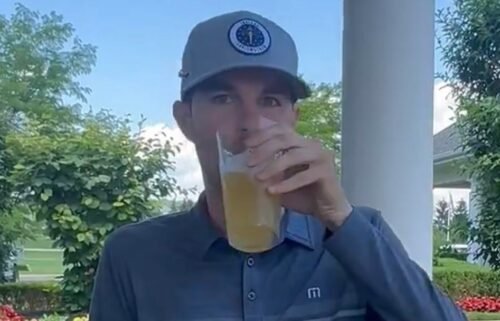 Nick Bienz sips a beer before heading into a playoff to qualify for the PGA Tour's Rocket Mortgage Classic