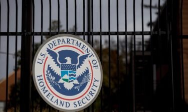 The US Department of Homeland Security seal hangs on a fence at the agency's headquarters in Washington