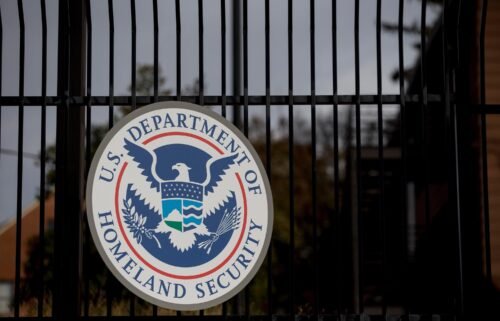 The US Department of Homeland Security seal hangs on a fence at the agency's headquarters in Washington