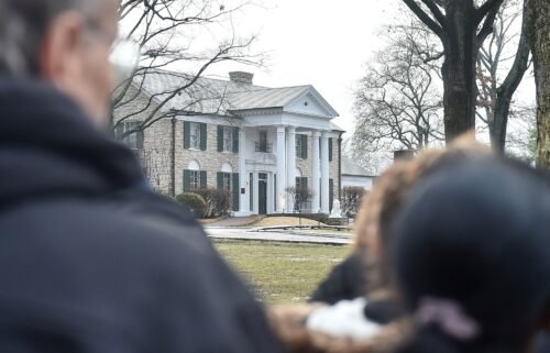 Fans gather outside Graceland to pay their respects at the memorial for Lisa Marie Presley in January 2023 in Memphis