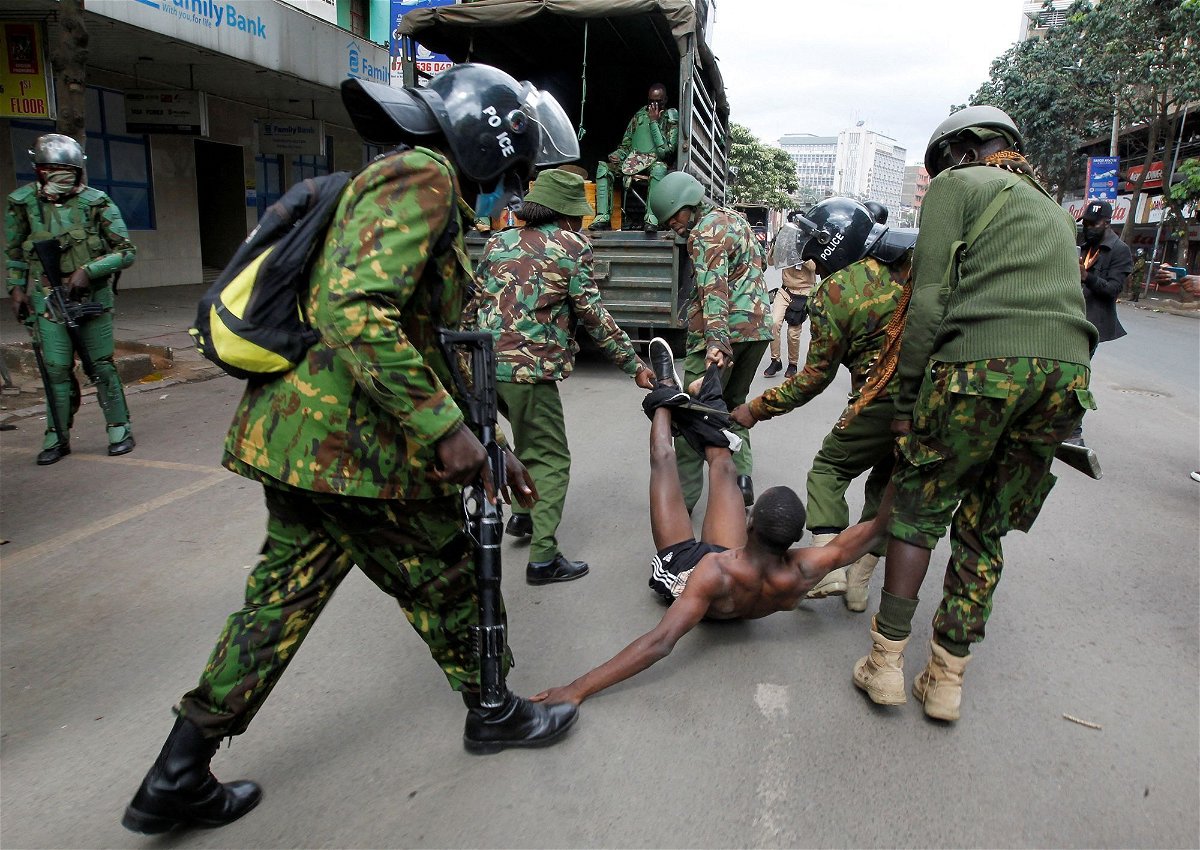 <i>Monicah Mwangi/Reuters via CNN Newsource</i><br/>Police officers detain a man during a demonstration over police killings of people protesting against Kenya's finance bill