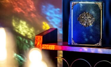 A bible is lit by stained glass in the sanctuary at St. Luke's United Methodist Church in Oklahoma City on Friday