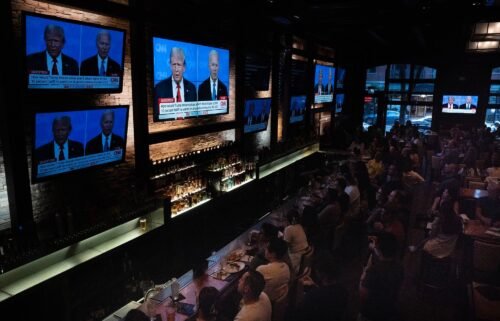 Guests at the Old Town Pour House watch the debate between President Joe Biden and presumptive Republican nominee former President Donald Trump on June 27
