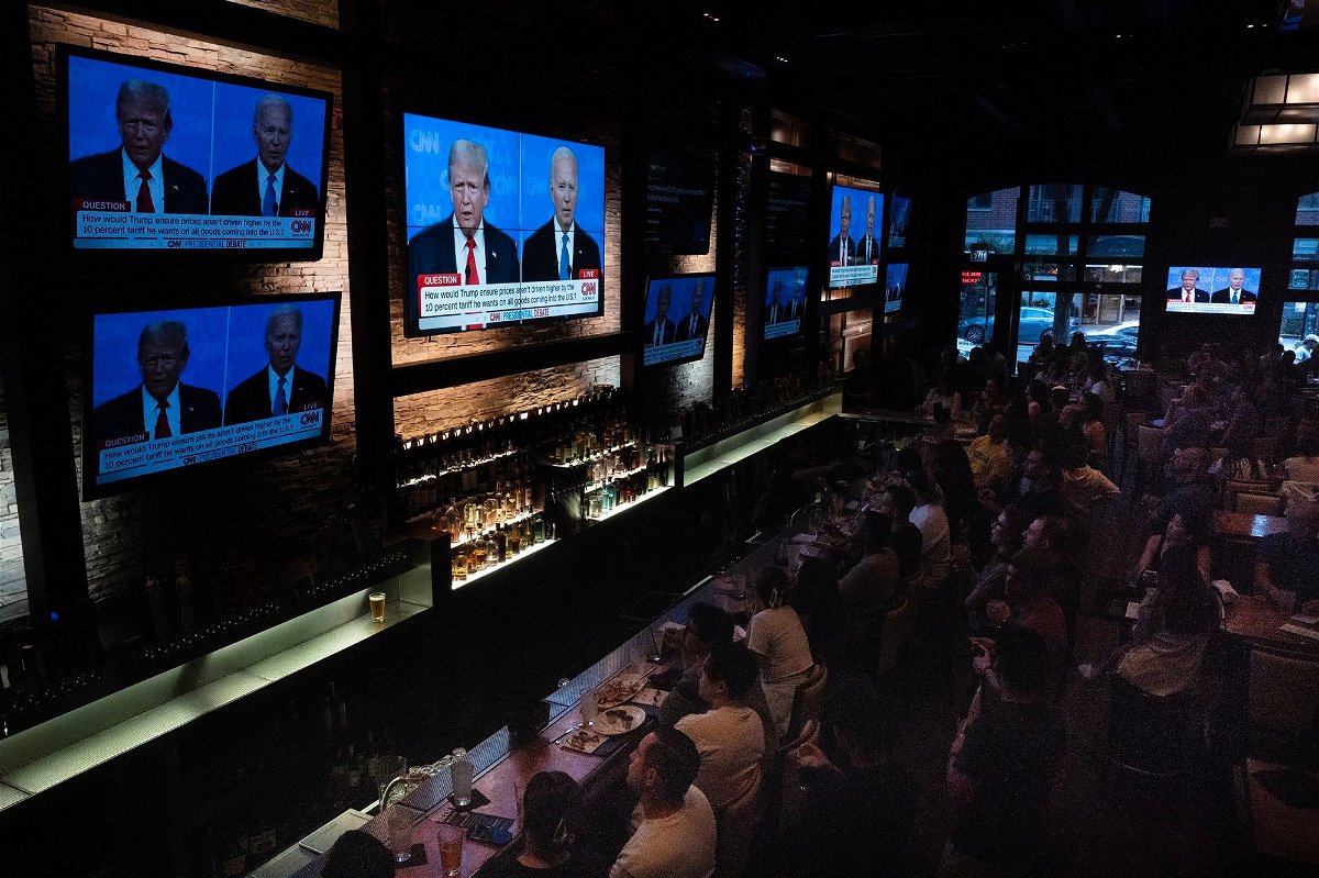 <i>Scott Olson/Getty Images via CNN Newsource</i><br/>Guests at the Old Town Pour House watch the debate between President Joe Biden and presumptive Republican nominee former President Donald Trump on June 27