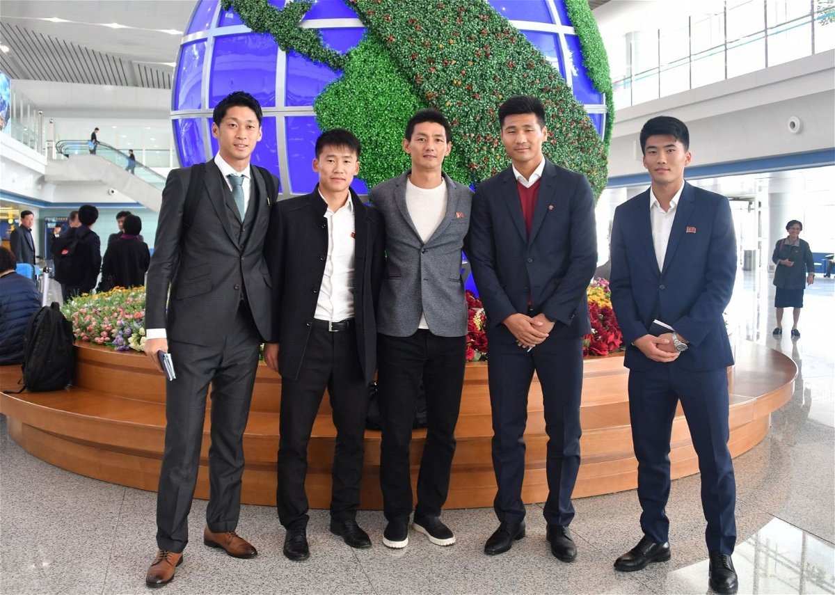 <i>An Yong Hak via CNN Newsource</i><br/>An Yong Hak (in the middle) and Han Kwang Song (far right) in Pyongyang in 2019 with other North Korean soccer players.