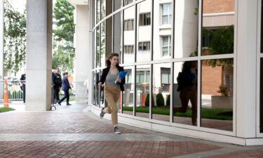 CNN runner Macayla Cook runs to deliver the news about the verdict in Hunter Biden's trial on June 11