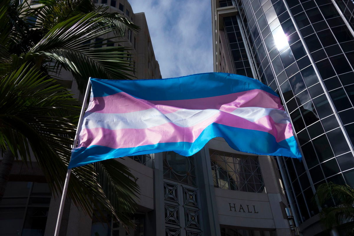 <i>Alex Menendez/AP/File via CNN Newsource</i><br/>A transgender flag is seen waving during a gathering at City Hall in Orlando