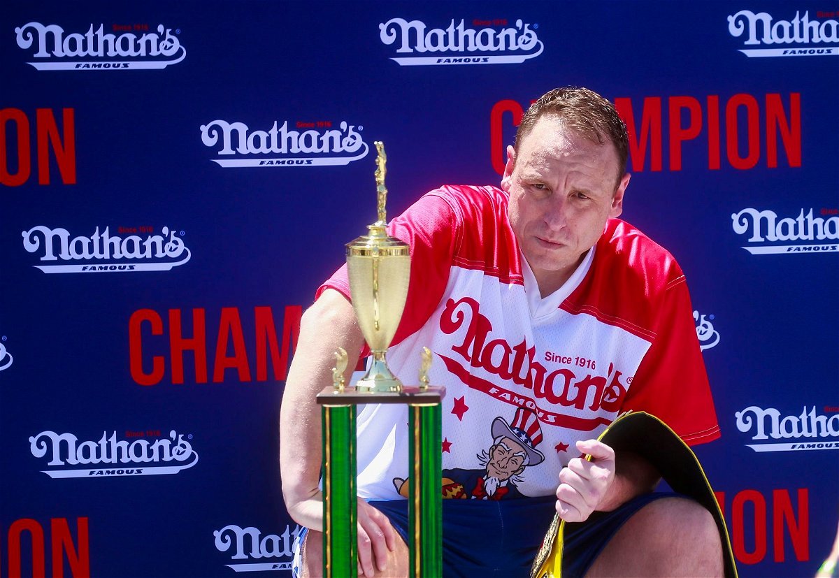 <i>Kena Betancur/Getty Images via CNN Newsource</i><br/>Joey Chestnut sits with the trophy and belt after he won first place
