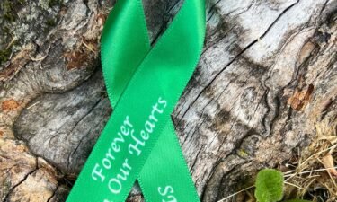 Newtown High's Class of 2024 will wear green and white ribbons on their graduation gowsn to remember those they lost.