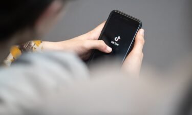 A teenager looks at a smartphone with the TikTok logo displayed on April 25 in Berlin. A survey found that most US TikTok users don't use the app for politics.