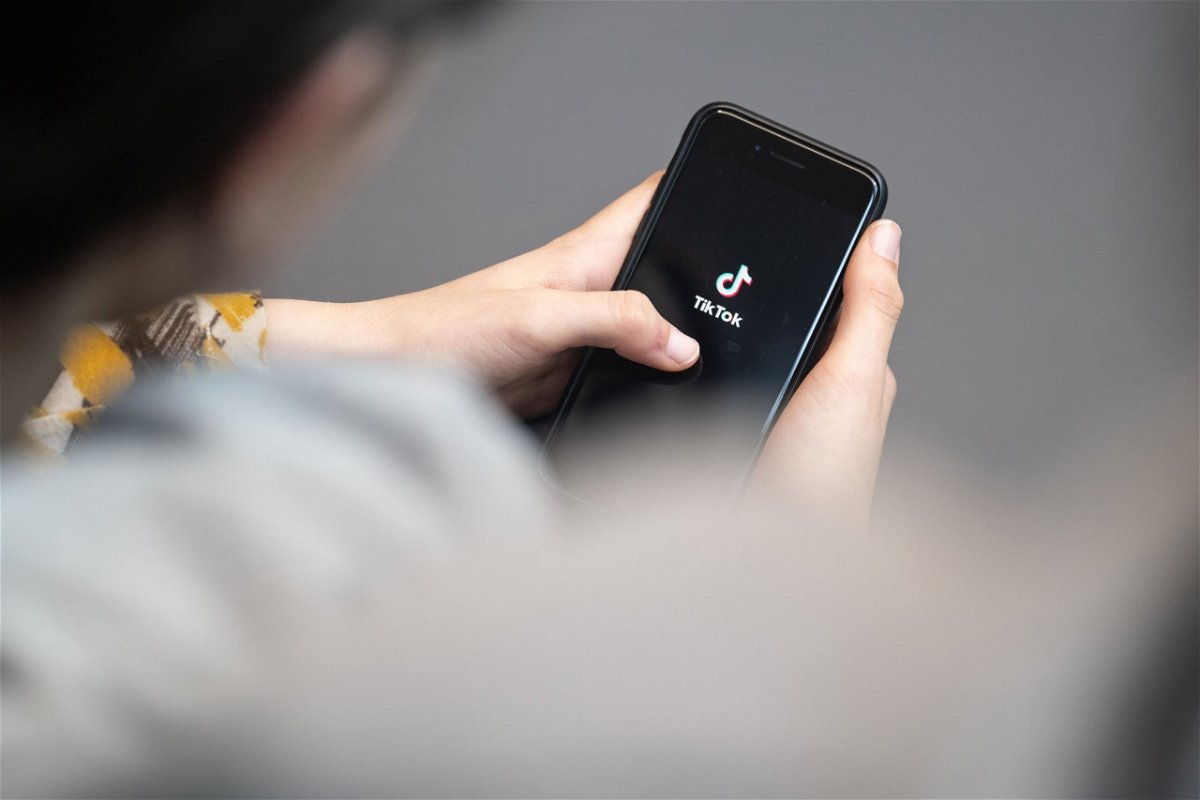 <i>Hannes P. Albert/picture alliance/Getty Images via CNN Newsource</i><br/>A teenager looks at a smartphone with the TikTok logo displayed on April 25 in Berlin. A survey found that most US TikTok users don't use the app for politics.