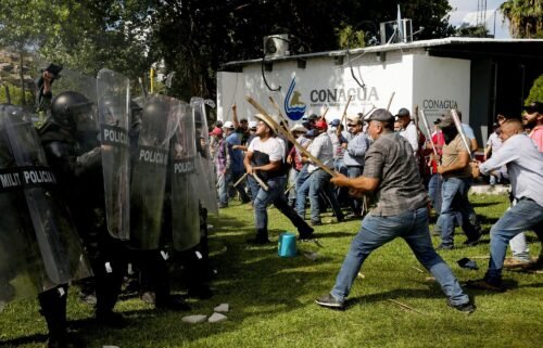 Farmers clash with the Mexican National Guard during a protest against the decision to divert water from La Boquilla dam to the US
