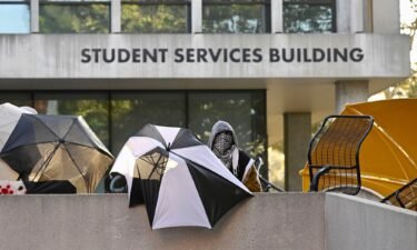 Pro-Palestinian student protesters barricade the entrance to the student services building at California State University