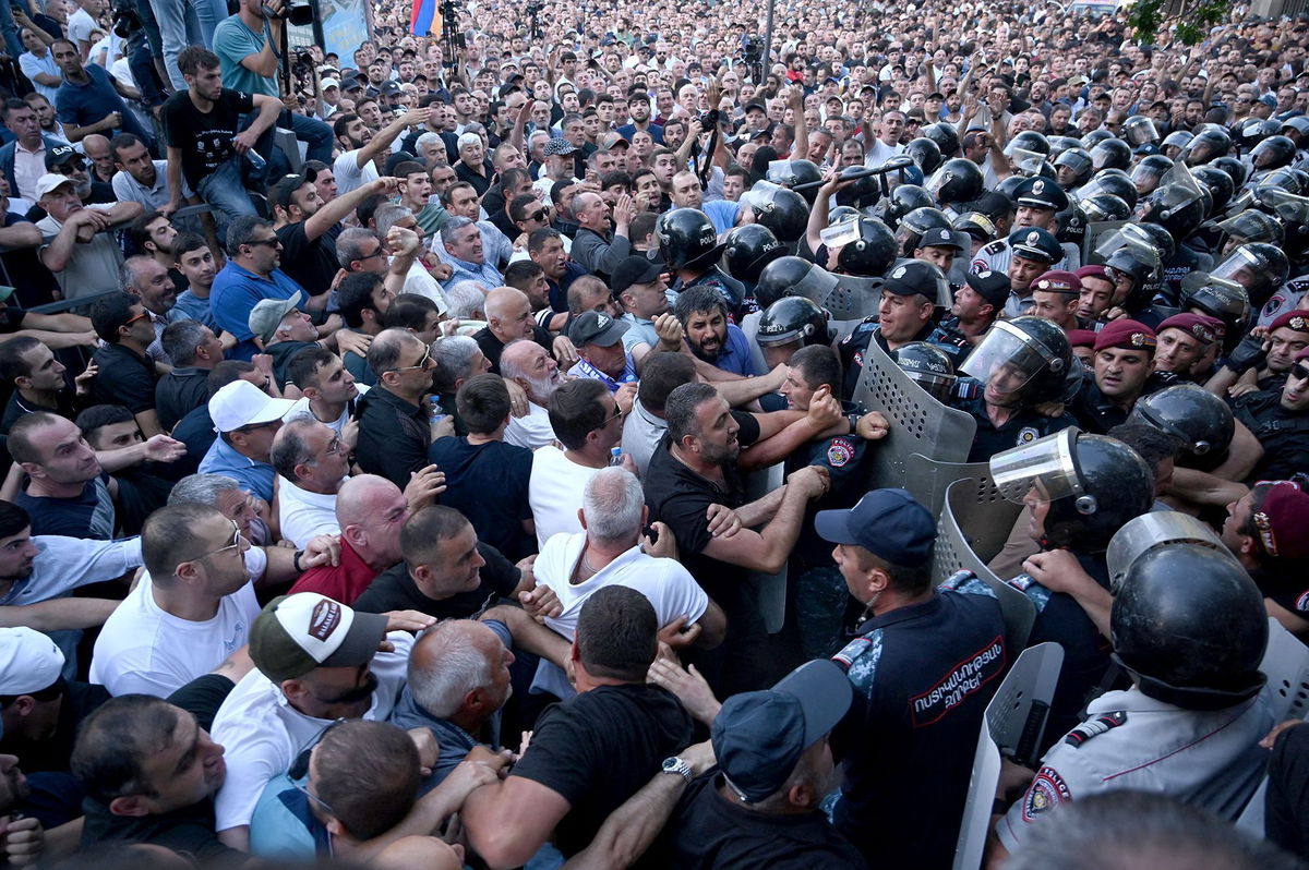 <i>Karen Minasyan/AFP/Getty Images via CNN Newsource</i><br/>Anti-government protesters clash with police outside the parliament in Yerevan