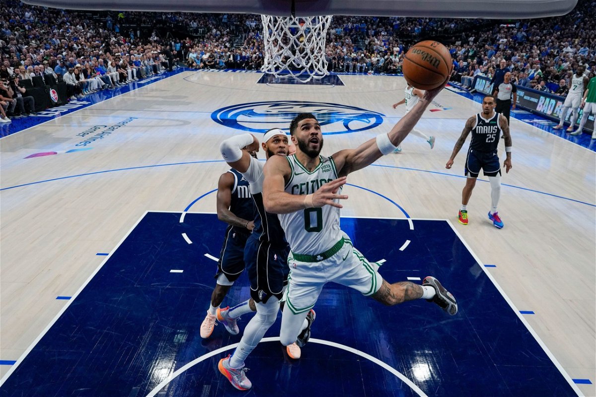 <i>Julio Cortez/Pool/AP via CNN Newsource</i><br/>Boston Celtics forward Jayson Tatum (0) goes up for a basket in front of Dallas Mavericks forward P.J. Washington during the first half in Game 3 of the NBA basketball finals