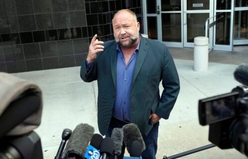 Right-wing conspiracy theorist Alex Jones speaks to the media as he arrives at the federal courthouse for a hearing in front of a bankruptcy judge Friday