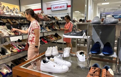 People shop for shoes in a store at The Village at Corte Madera on May 30