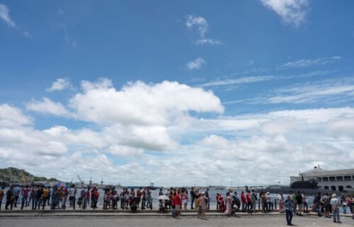 People line up to visit Russian frigate Admiral Gorshkov (not pictured) docked in Havana's bay