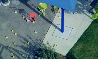 Evidence markers are placed at the scene of a shooting at a splash pad in Rochester Hills