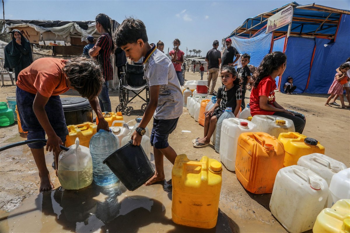 <i>Abed Rahim Khatib/Anadolu/Getty Images via CNN Newsource</i><br/>Palestinians queue up to receive clean drinking water distributed by aid organizations in Deir al-Balah.