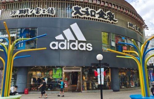 People walk past the flagship store of Adidas in Shanghai