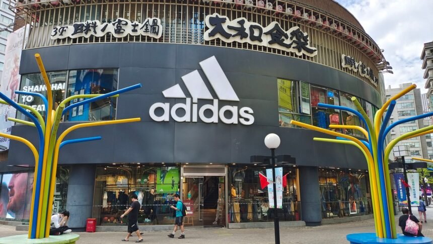 <i>CFOTO/Future Publishing/Getty Images via CNN Newsource</i><br/>People walk past the flagship store of Adidas in Shanghai