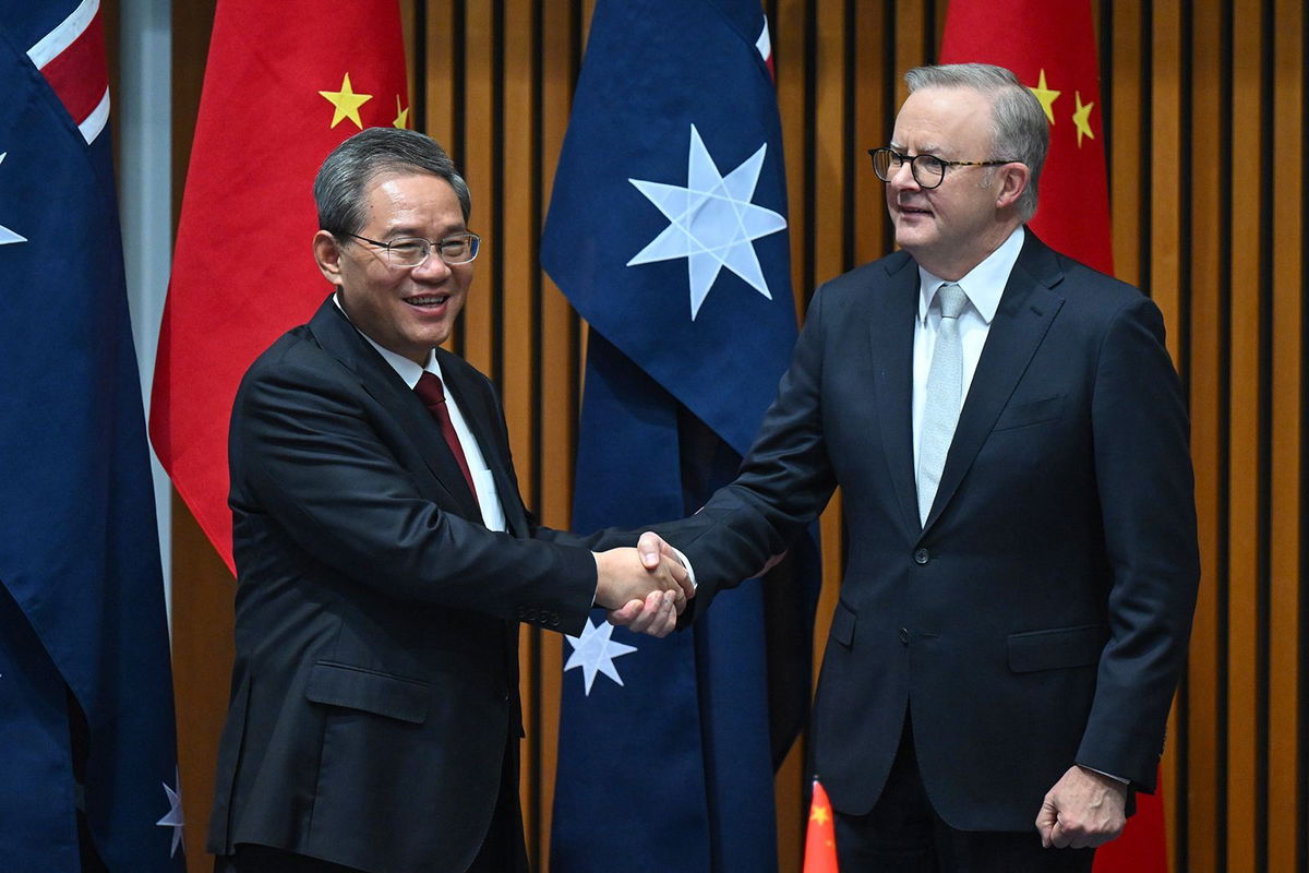 <i>Lukas Coch/AP via CNN Newsource</i><br/>Chinese Premier Li Qiang and Australia's Prime Minister Anthony Albanese shake hands during a signing ceremony in Canberra on June 17.