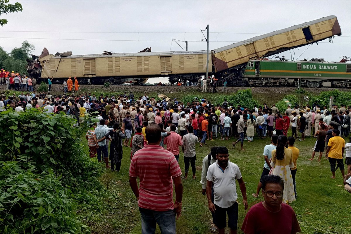 <i>Diptendu Dutta/AFP/Getty Images via CNN Newsource</i><br/>People gather at the site of a train collision in Nirmaljote