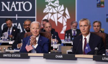 NATO Secretary General Jens Stoltenberg (R) and U.S. President Joe Biden attend the opening high-level session of the 2023 NATO Summit in July 2023 in Vilnius