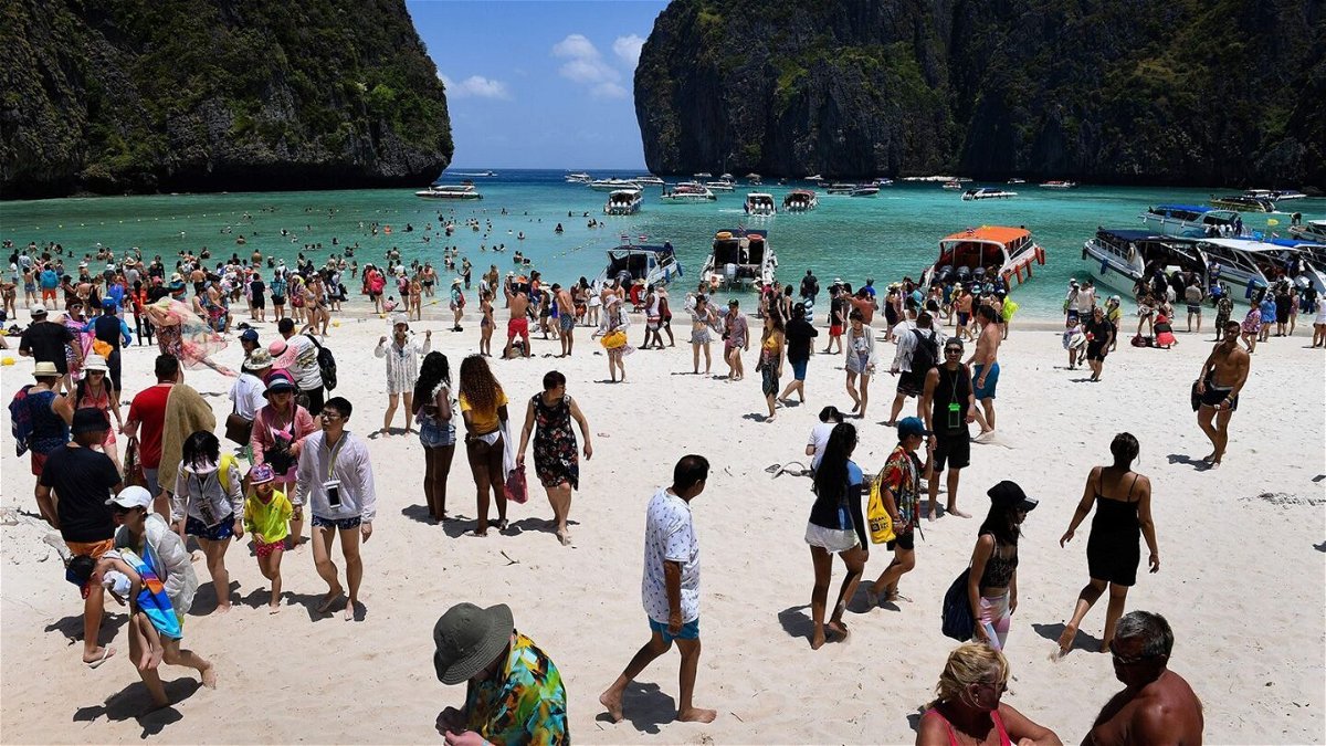 <i>Lillian Suwanrumpha/AFP/Getty Images via CNN Newsource</i><br/>This 2018 photo shows tourists swarming Thailand's Maya Bay