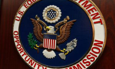 The emblem of the US Equal Employment Opportunity Commission is shown on a podium in Denver