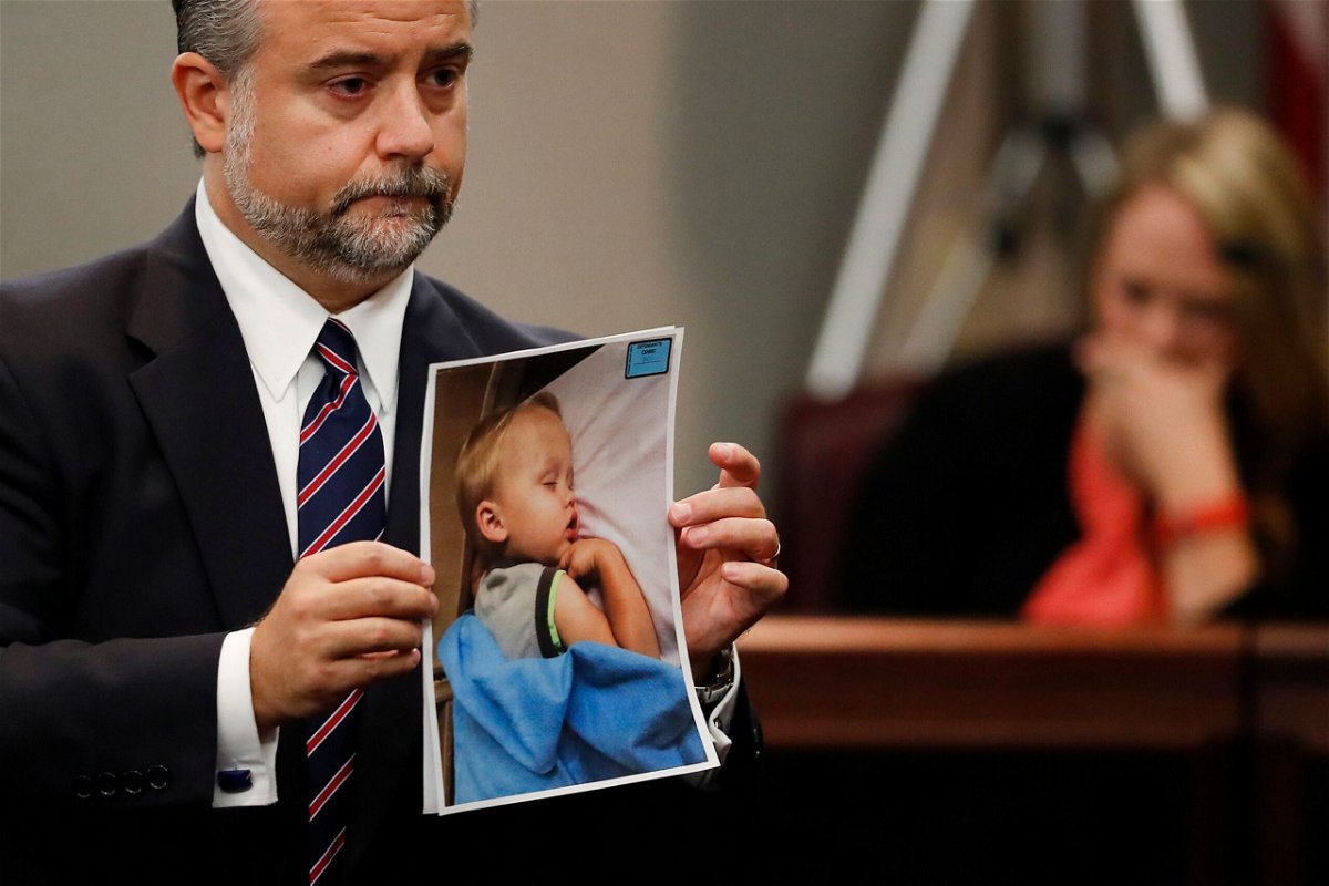 <i>John Bazemore/AP via CNN Newsource</i><br/>Defense attorney Maddox Kilgore holds a photo of Cooper Harris during Justin Ross Harris' murder trial in 2016.