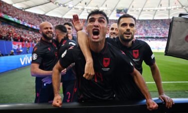 Albania players celebrate scoring the first goal of the game.